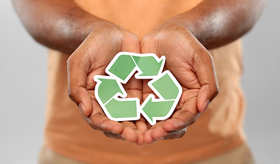 Image showing close up of man holding green recycling sign