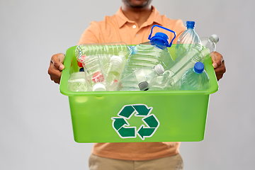 Image showing close up of young man sorting plastic waste