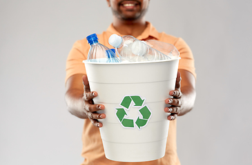 Image showing close up of young indian man sorting plastic waste