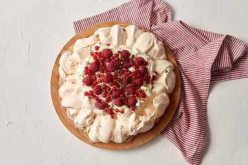 Image showing pavlova meringue cake with berries on wooden board