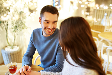 Image showing happy couple drinking tea at cafe