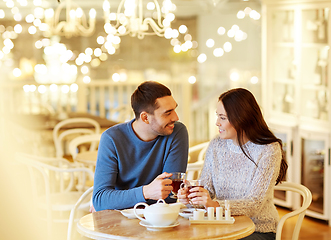 Image showing happy couple drinking tea at cafe