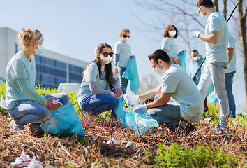 Image showing volunteers with garbage bags cleaning park area