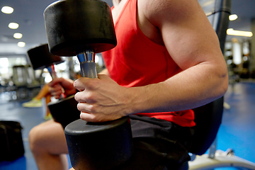 Image showing close up of man with dumbbells exercising in gym