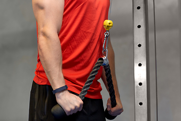 Image showing close up of man exercising on cable machine in gym