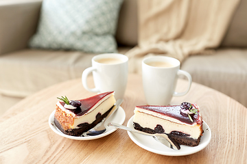 Image showing pieces of chocolate cake on wooden table