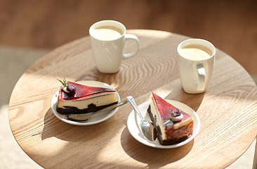 Image showing pieces of chocolate cake on wooden table