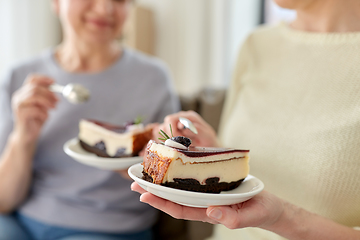 Image showing close up of women eating cake at home