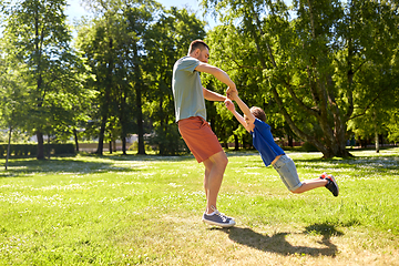 Image showing happy father with son playing in summer park