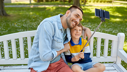 Image showing father and son taking selfie with phone at park