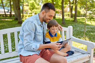 Image showing father and son with tablet pc computer at park