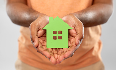 Image showing close up of african man holding green house