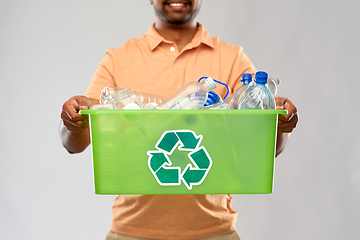 Image showing close up of young man sorting plastic waste