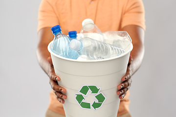 Image showing close up of young man sorting plastic waste