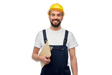Image showing happy worker or builder in helmet with clipboard