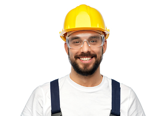 Image showing happy male worker or builder in helmet and overall