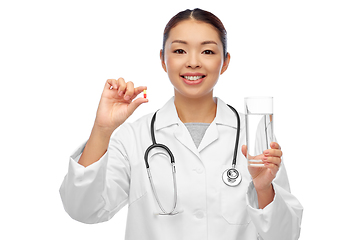 Image showing asian doctor with medicine and glass of water