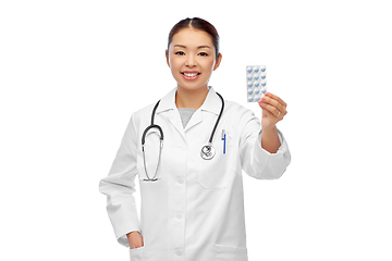 Image showing happy asian female doctor or nurse with medicine