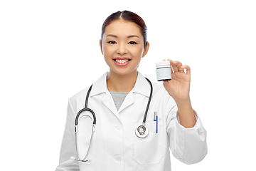 Image showing smiling asian female doctor or nurse with medicine