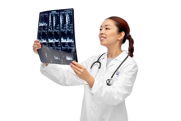 Image showing happy smiling asian female doctor looking at x-ray