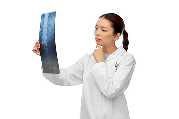 Image showing asian female doctor looking at x-ray of spine