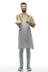 Image showing happy smiling waiter in apron with cup of coffee