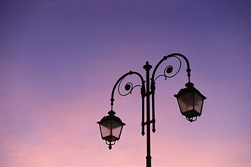 Image showing Beautiful vintage street lamp against a bright sunrise sky