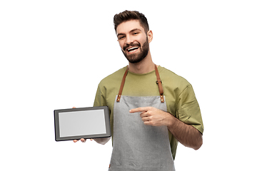 Image showing smiling waiter in apron showing tablet pc computer