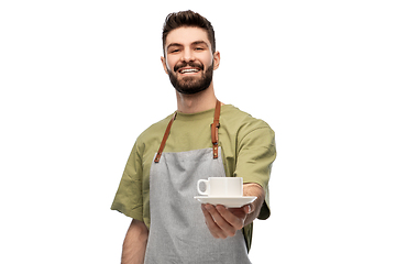 Image showing happy smiling waiter in apron with cup of coffee