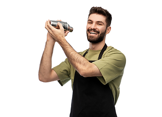 Image showing happy barman with shaker preparing