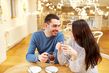 Image showing happy couple drinking tea at cafe