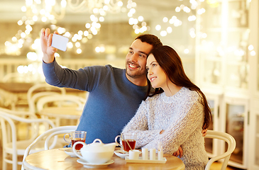 Image showing couple taking smartphone selfie at cafe restaurant