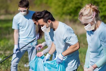 Image showing volunteers in masks with cleaning garbage at park