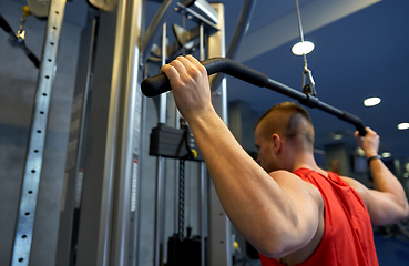 Image showing close up of man exercising on cable machine in gym