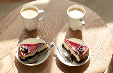 Image showing pieces of chocolate cake on wooden table