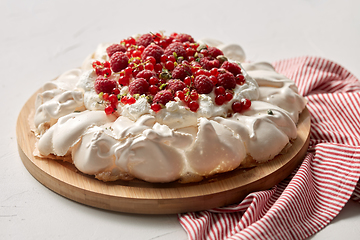 Image showing pavlova meringue cake with berries on wooden board