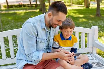 Image showing father and son with smartphone at park