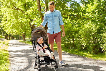 Image showing happy father with child in stroller at summer park