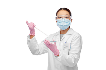 Image showing asian female scientist in mask working on vaccine