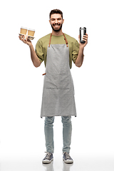 Image showing happy waiter with takeout coffee cups and tumbler