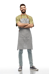 Image showing happy smiling barman in apron with crossed arms