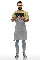 Image showing smiling waiter in apron with tablet pc computer