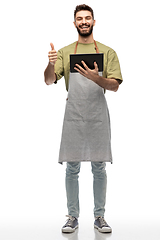 Image showing smiling waiter with tablet pc showing thumbs up