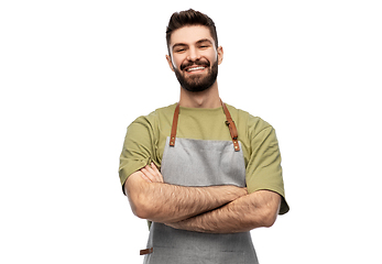 Image showing happy smiling barman in apron with crossed arms