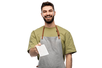 Image showing happy smiling barman in apron with bill