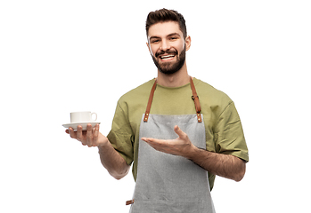 Image showing happy smiling waiter in apron with cup of coffee