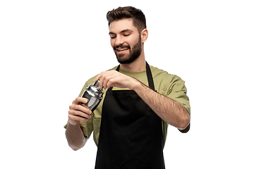 Image showing happy barman with shaker preparing