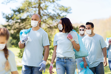 Image showing volunteers in masks with garbage bags in park