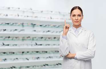 Image showing female doctor pointing finger up at optical store