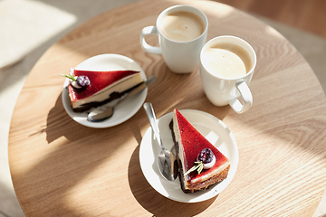 Image showing pieces of chocolate cake on wooden table